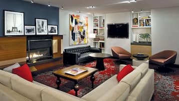Cozy living room with a fireplace, comfortable seating, and a flat-screen TV.