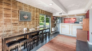 A modern kitchen with a brick wall, a glass counter, and a sign for Econo Lodge by Choice Hotels. - Econo Lodge Kearney - Liberty (Kearney)