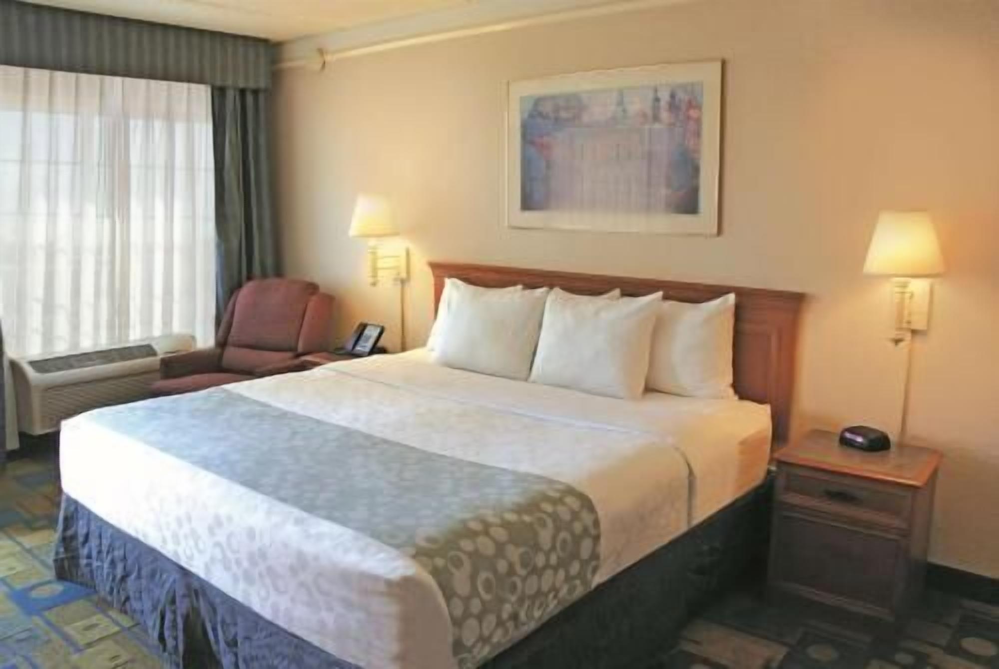 Premium bedding, desk, laptop workspace, blackout drapes