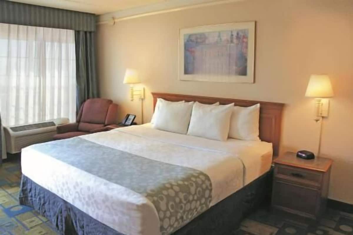 Premium bedding, desk, laptop workspace, blackout drapes