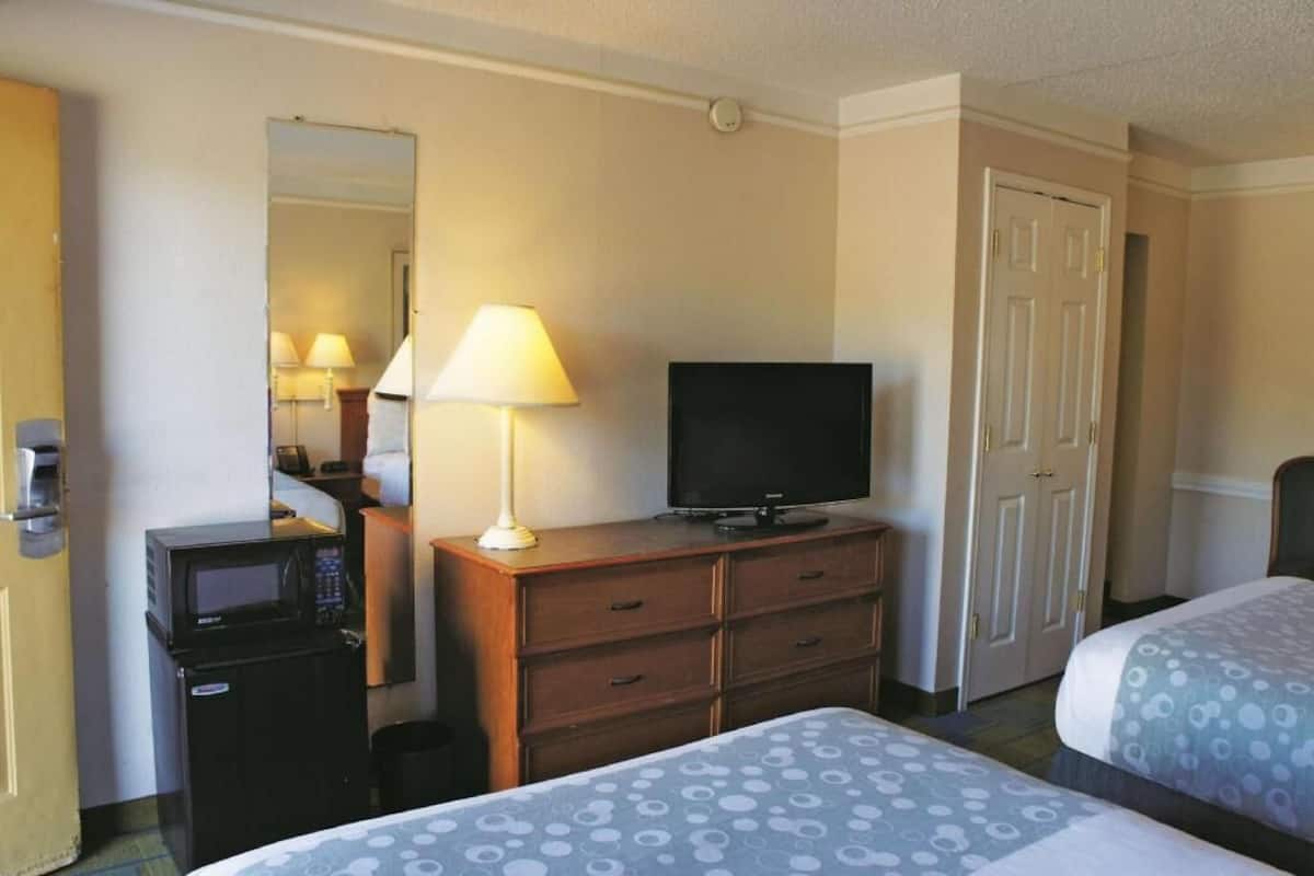 Premium bedding, desk, laptop workspace, blackout drapes