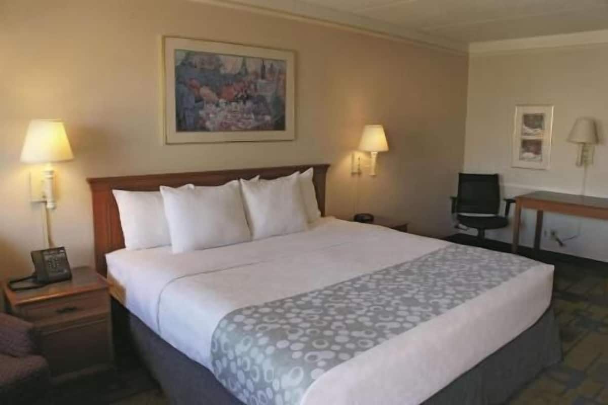 Premium bedding, desk, laptop workspace, blackout drapes