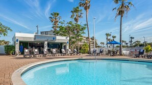 A pool area with lounge chairs and a building labeled "The Blue Flip". - Best Western Cocoa Beach - Port Canaveral (Cocoa Beach)