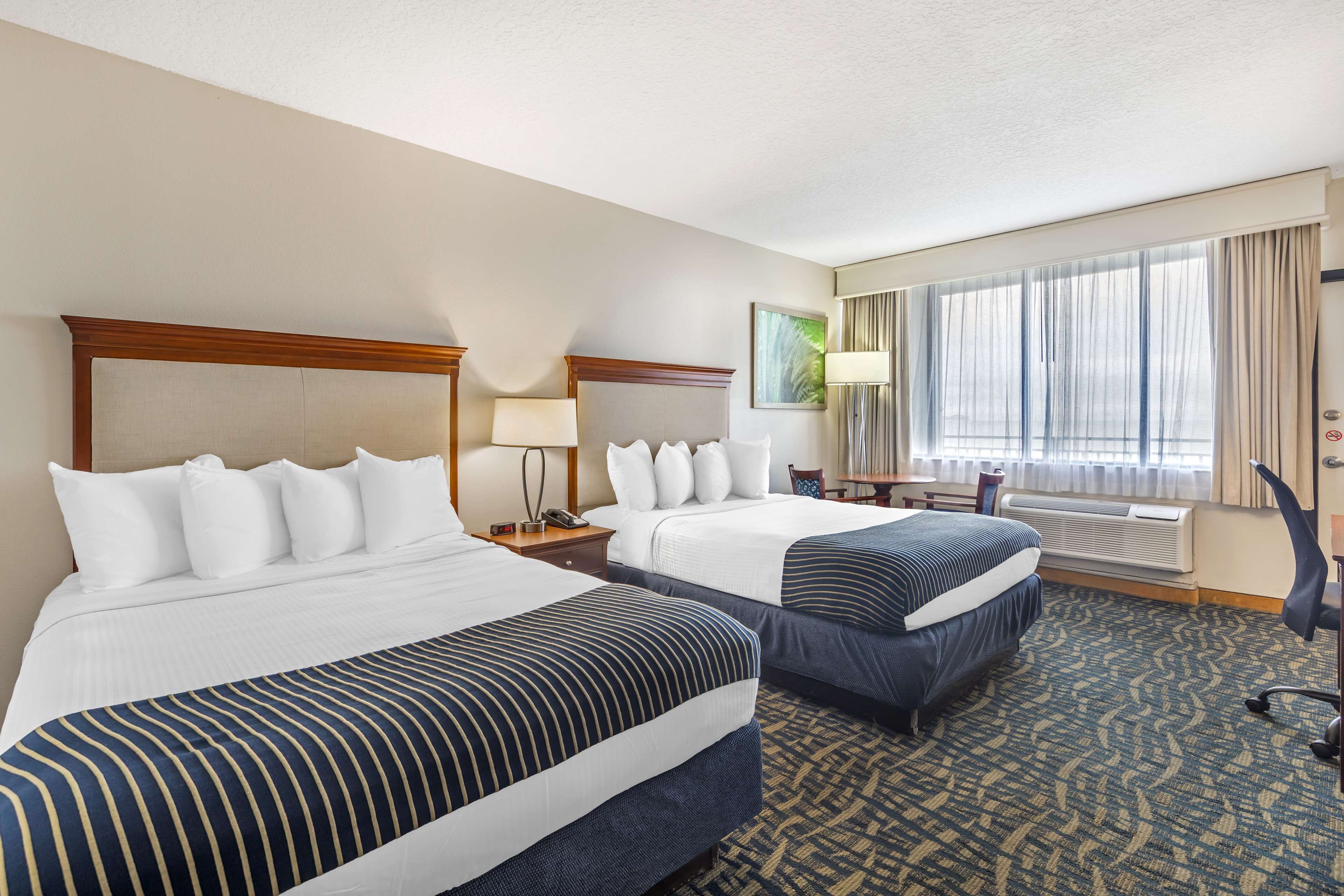 pillow-top beds, desk, laptop workspace, blackout curtains