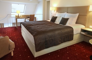 A hotel room with a large bed, a desk, and a chair. - Best Western Hotel Zur Post (Bremen)