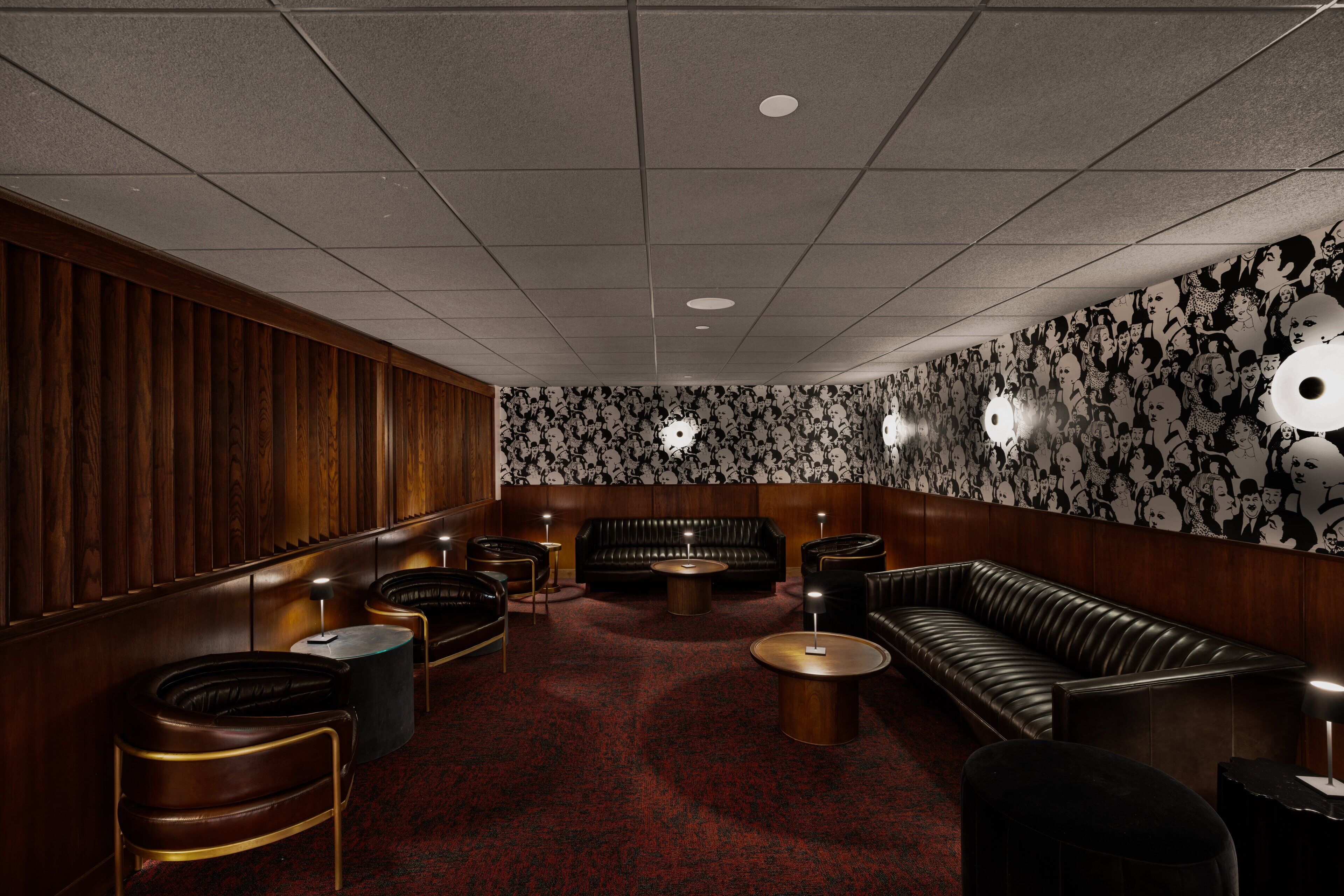 A lounge area with leather sofas, armchairs, and a coffee table.