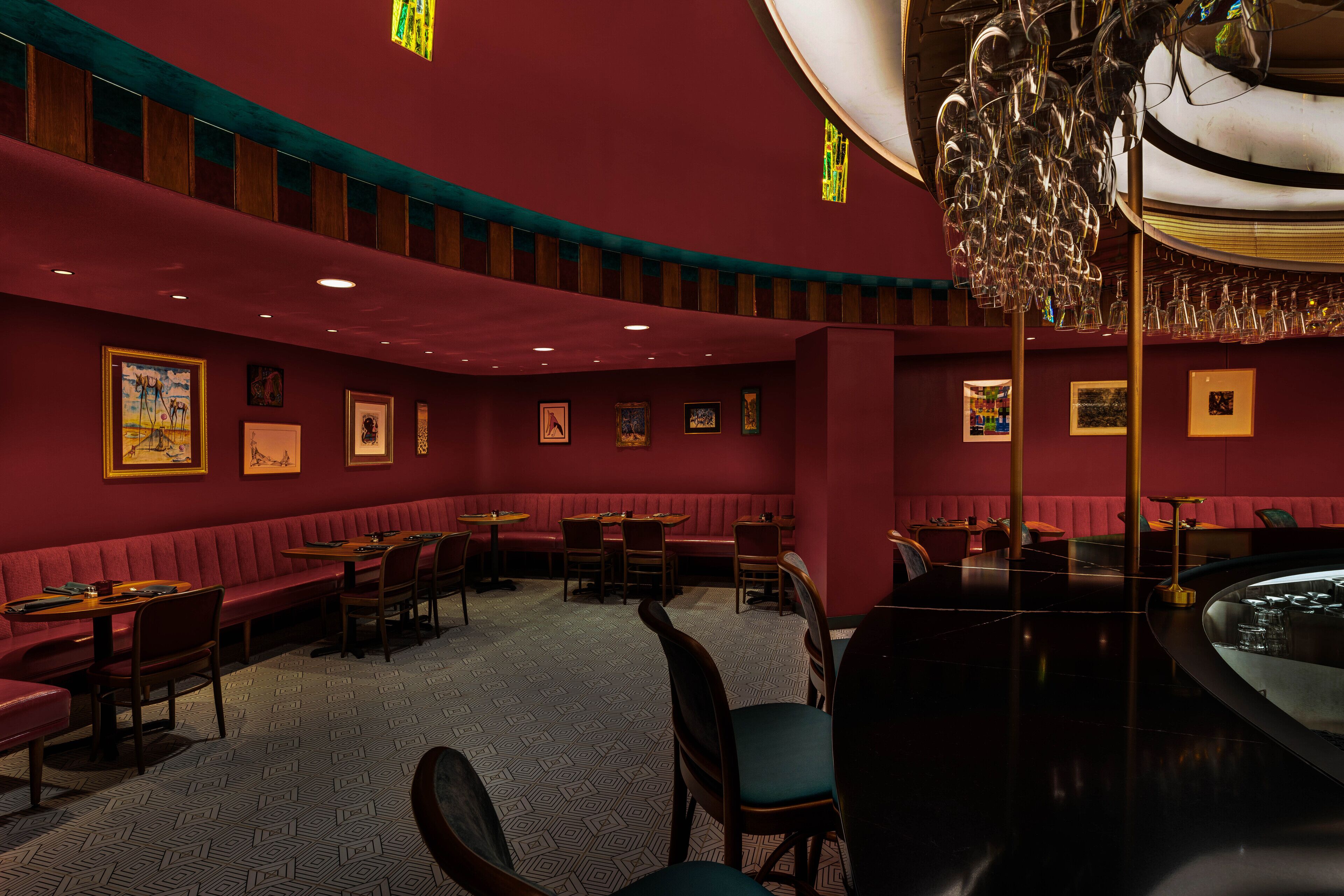 A restaurant with booths, tables, and a bar area.
