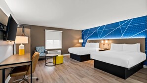 A hotel room with a bed, two bedside tables, a desk with a chair, a small table with a chair, and a TV. - Comfort Inn & Suites Salt Lake City I-80 I-15 Downtown (Salt Lake City)