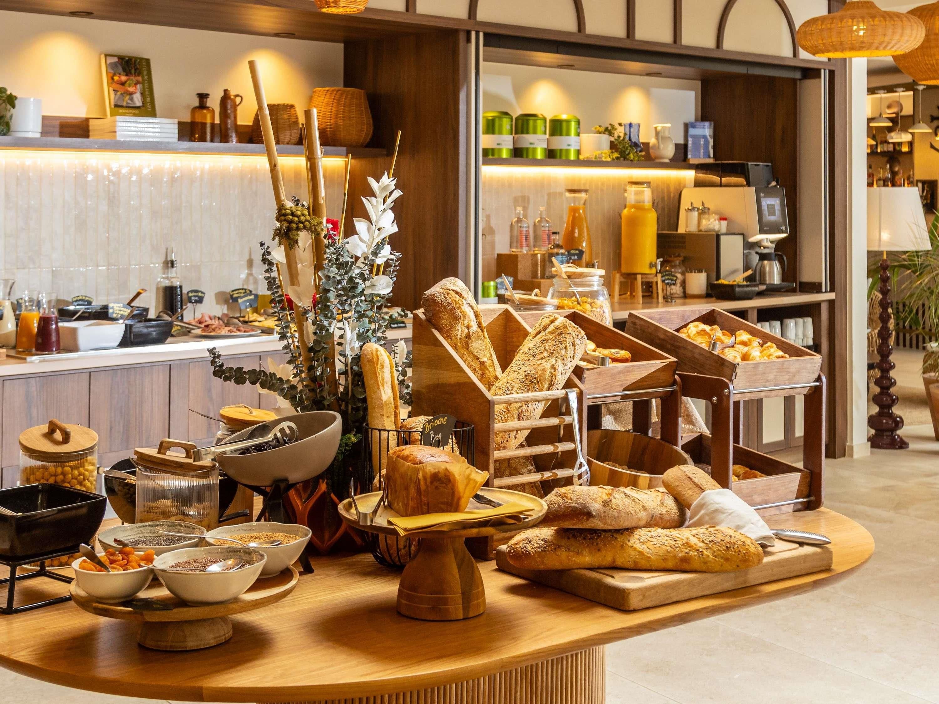 A buffet setup with various food items and condiments.