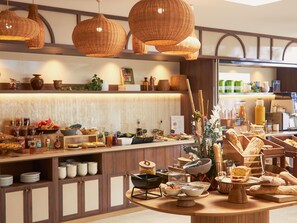 A buffet setup with various food items and a coffee station. - Mercure Arles Centre Arenes (Arles)