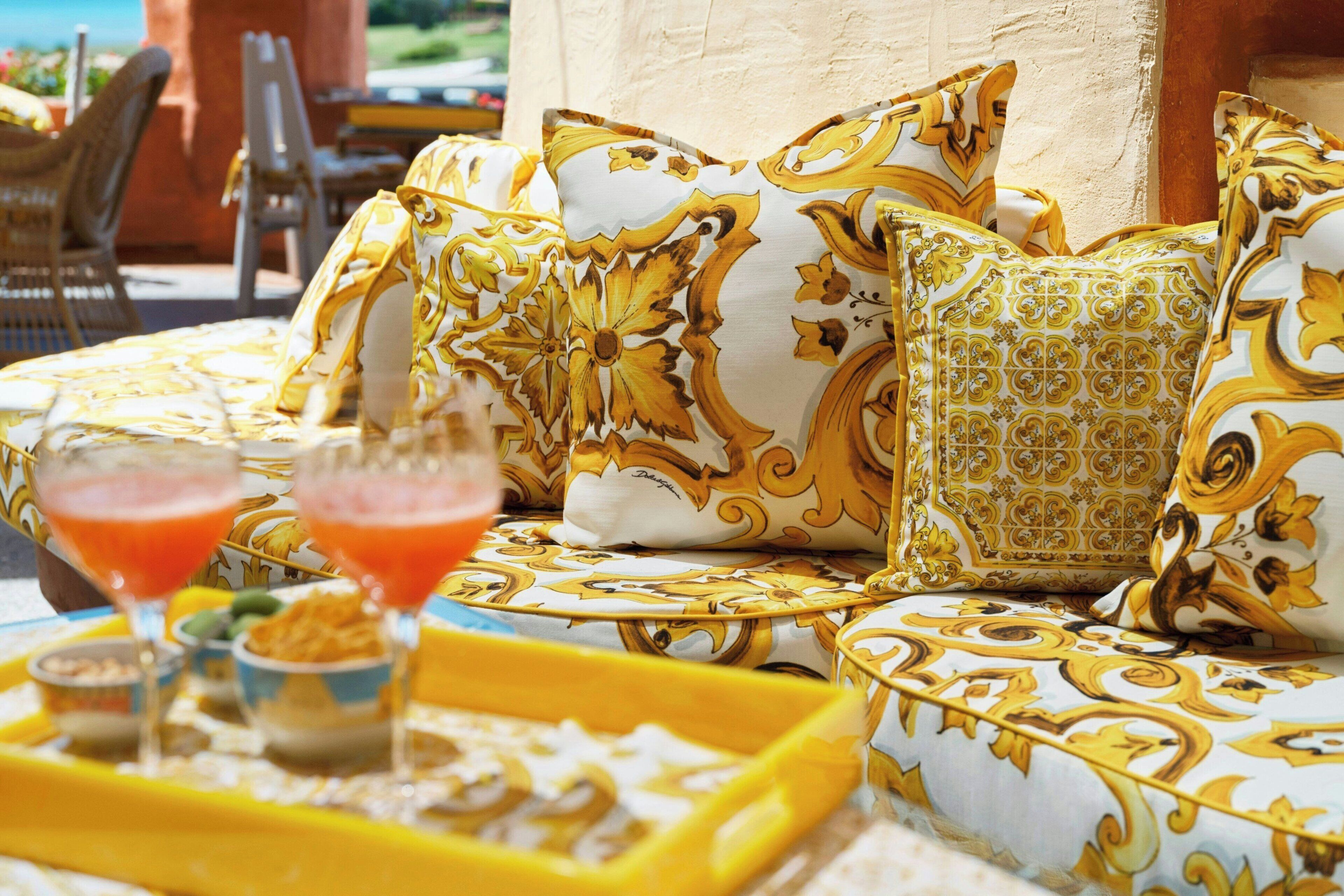 A seating area with patterned cushions and a tray with snacks and drinks.