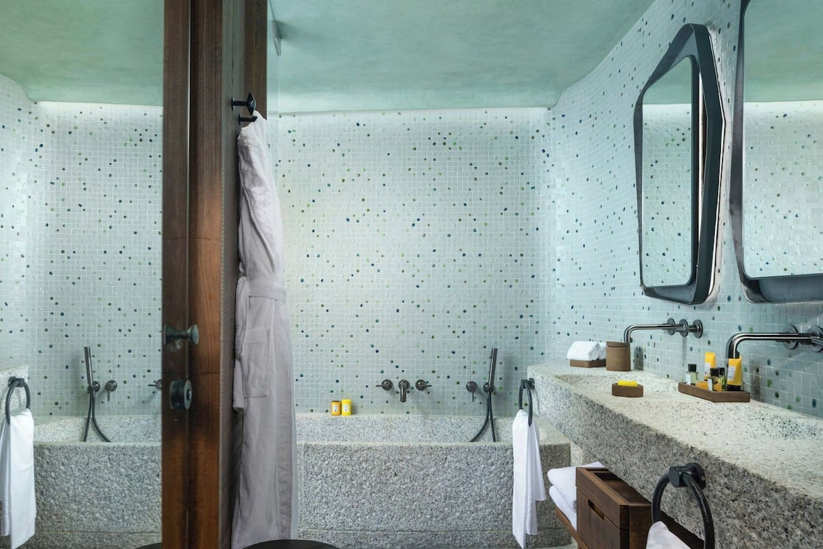 deluxe room, 1 king bed, garden access, garden view (design, original wing) | bathroom | rainfall showerhead, designer toiletries, hair dryer, bathrobes