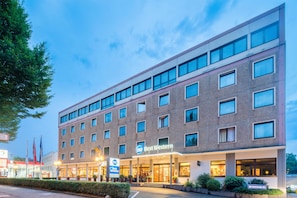 A multi-story hotel with a prominent 'Best Western' sign, a visible entrance, and a parking garage sign.