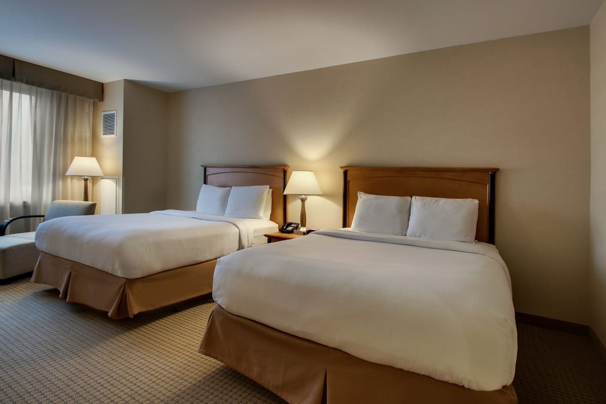 deluxe room, 2 queen beds, city view | premium bedding, in-room safe, desk, laptop workspace