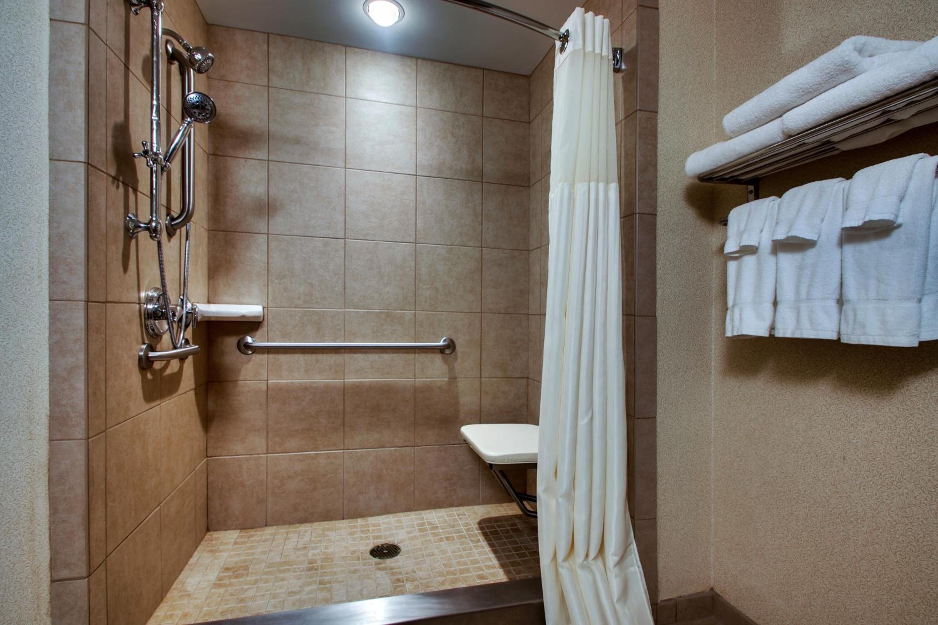combined shower/bathtub, designer toiletries, hair dryer, towels