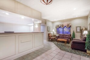 Welcome to our reception area, featuring a central desk, comfortable seating, and a beautiful window with a decorative valance.