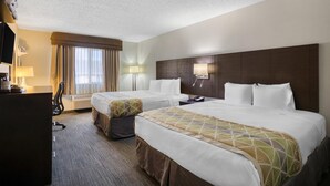 A hotel room with two beds, a desk, a chair, and a TV. - SureStay Plus by Best Western Montrose (Montrose)