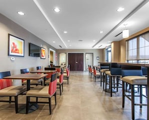 Relax in a spacious room with a large bed, flat-screen TV, and comfortable seating area.