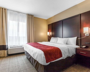 Relax in this inviting space with a large bed, bedside table, and nightstand.