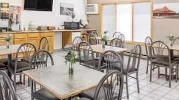 Enjoy meals in a spacious dining area with a central kitchen, flat-screen TV, and comfortable seating for gatherings.