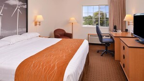 A hotel room with a bed, desk, chair, and a television. - Americas Best Value Inn & Suites Atlantic (Atlantic)
