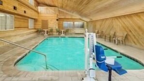 An indoor swimming pool with wooden walls and a tiled floor. - Americas Best Value Inn & Suites Atlantic (Atlantic)