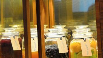 A display case with jars of preserved fruits and vegetables, and a stack of books on top.