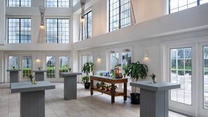 A spacious, well-lit interior with high ceilings, large windows, and multiple seating areas. - Grand Cayman Marriott Resort (Seven Mile Beach)