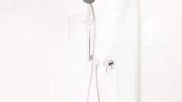 A shower with a handheld showerhead and a wall-mounted control.