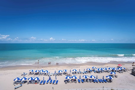 On the beach, beach cabanas, sun-loungers, beach towels. Costa d'Este Beach Resort and Spa
