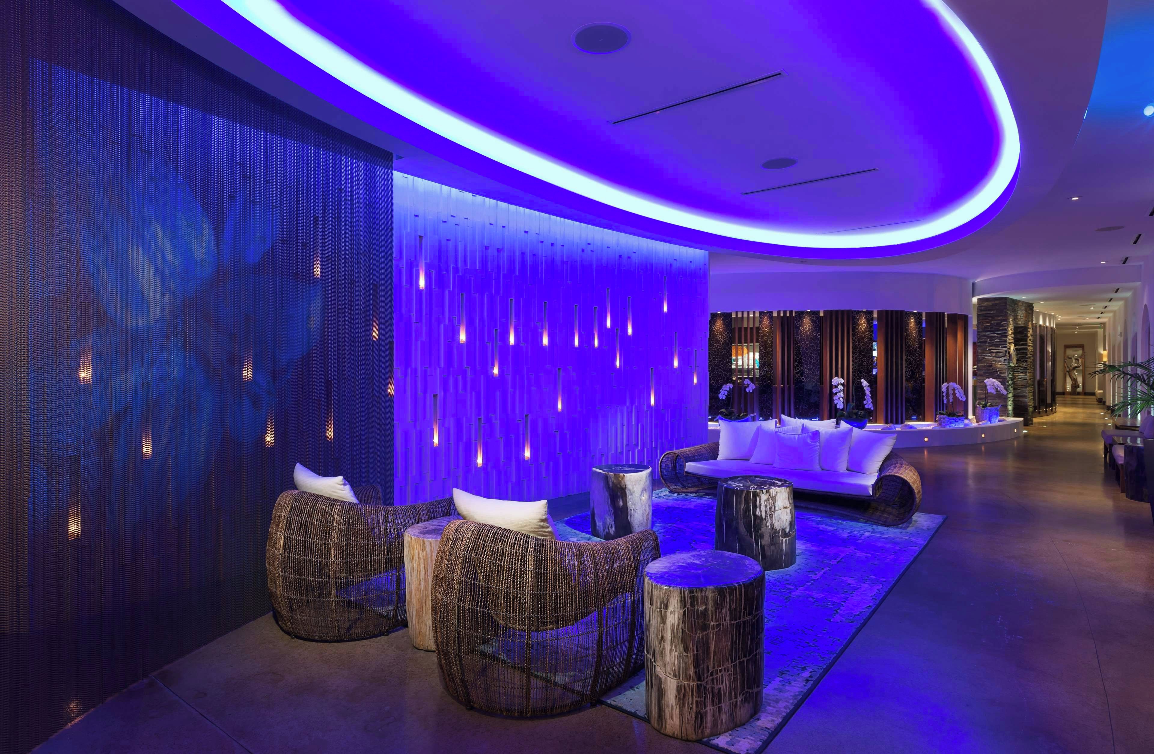 A modern lounge area with seating and a decorative wall.
