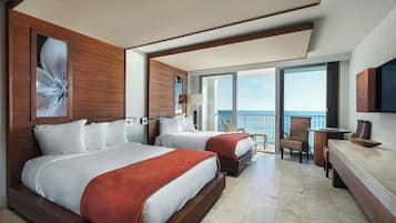 A hotel room with two beds, a large window with a view of the sea, a wooden headboard, and a flat-screen TV.