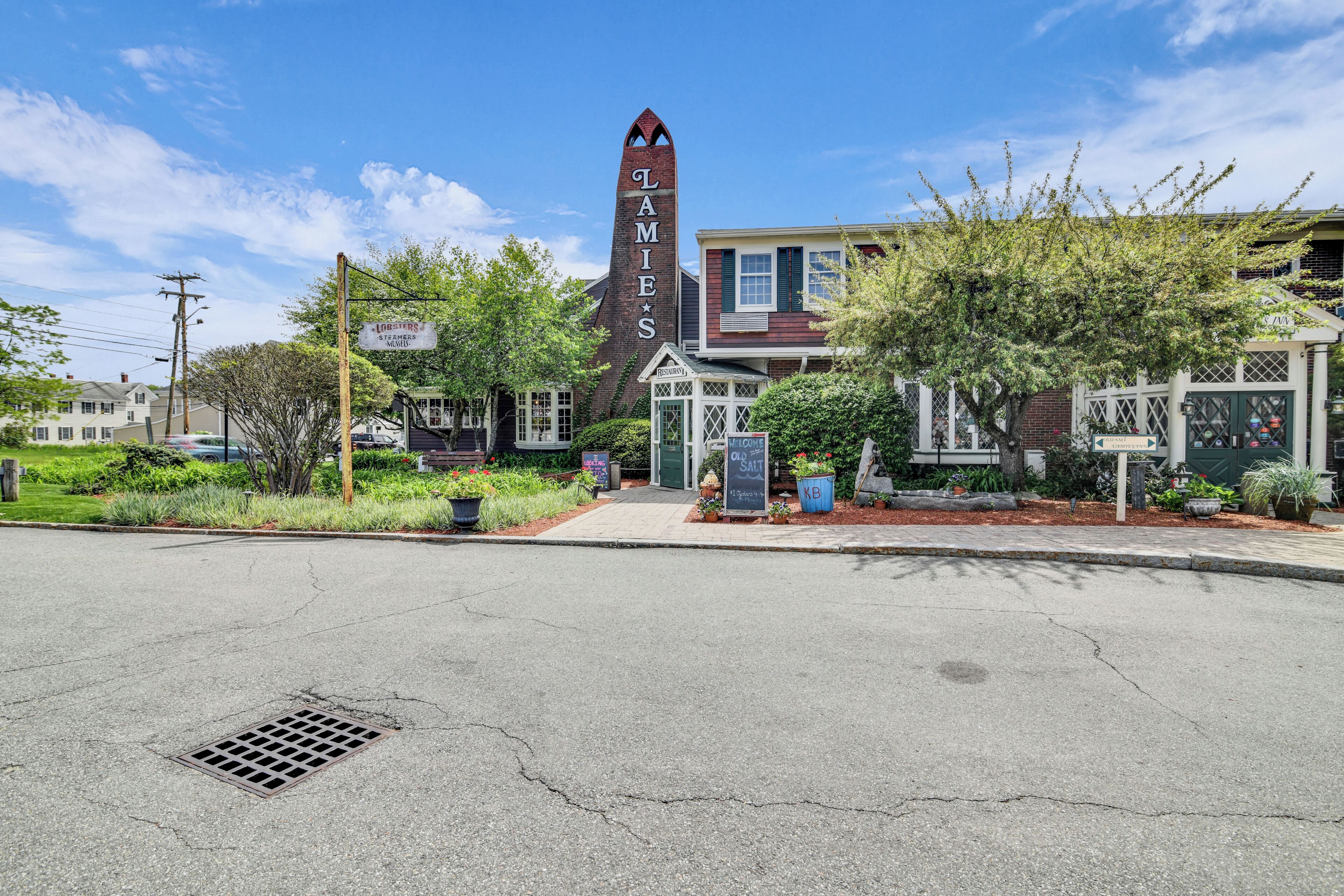 A building with a tall, narrow tower labeled 'LAMIES' and a sign for 'LODGERS & VINEYARDS.'