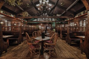 A traditional inn with wooden furniture, a chandelier, and a rustic interior. - Lamie's Inn and The Old Salt Restaurant (Hampton)