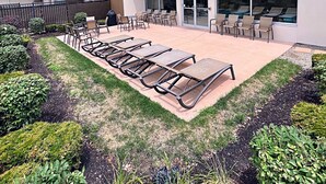 A modern building with a rooftop patio area featuring sun loungers and outdoor seating. - Holiday Inn Columbus Dwtn-Capitol Square by IHG (Columbus)