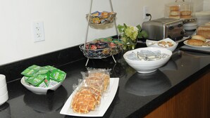 A breakfast buffet with various food items and condiments.