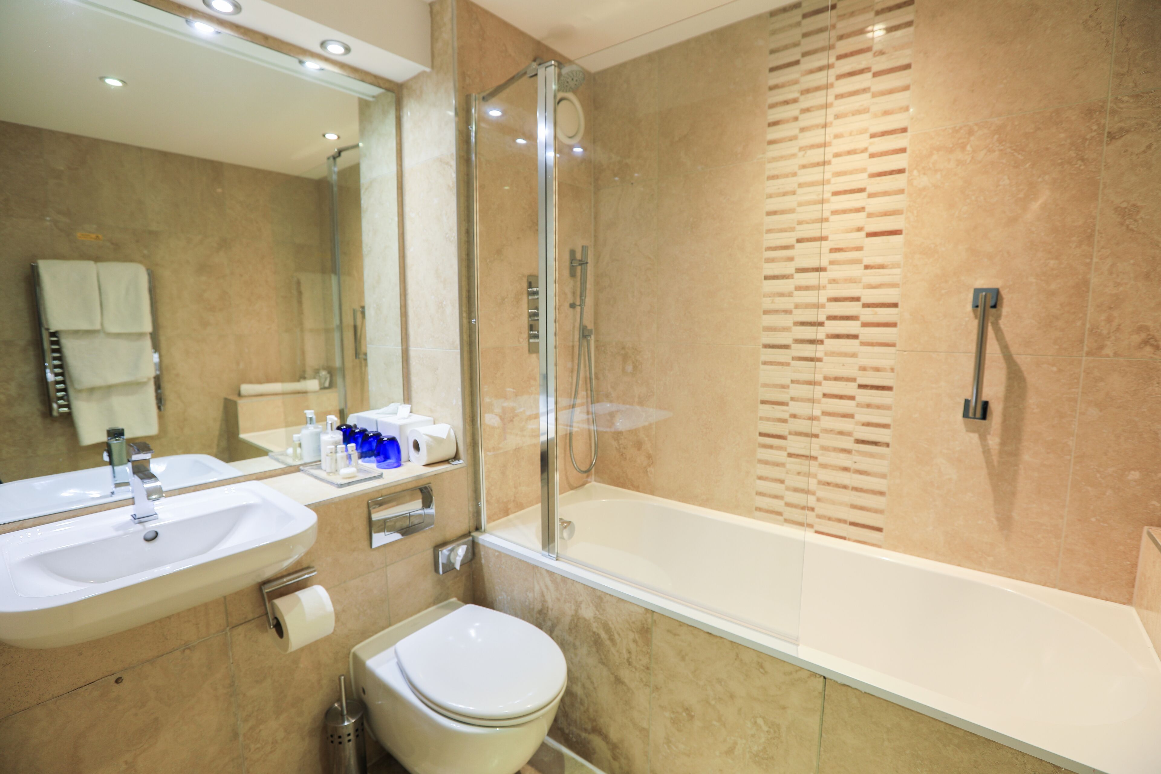 designer toiletries, hair dryer, bathrobes, slippers