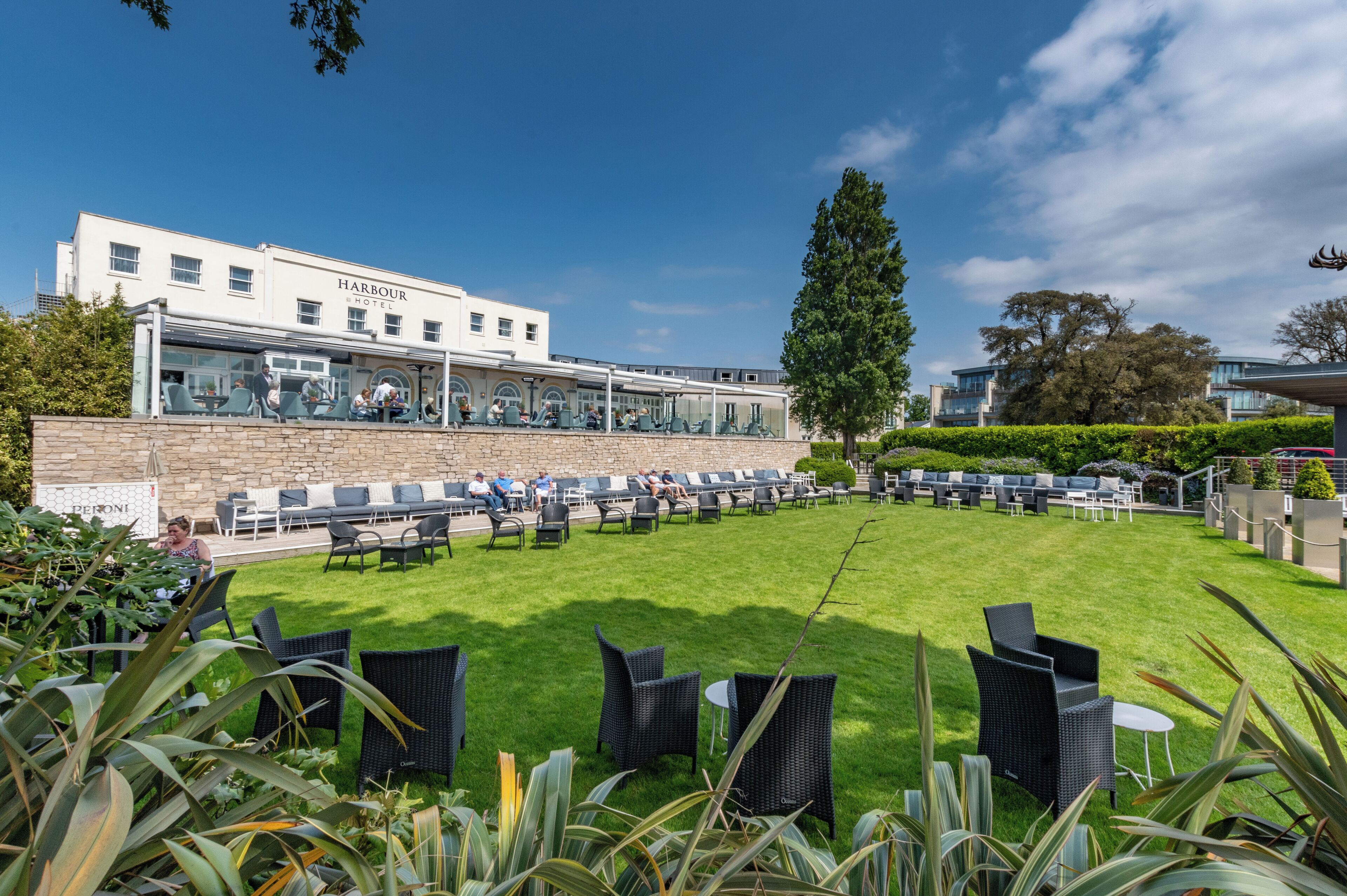 Un hotel con terraza y jardín.