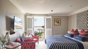 Un dormitorio con cama, escritorio, silla y vistas al exterior.