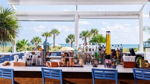 A bar with a view of the ocean, featuring a variety of bottles and bar tools. - Hilton Cabana Miami Beach Resort (Miami Beach)
