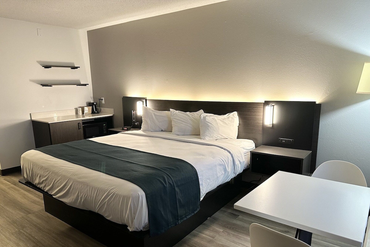 Desk, laptop workspace, blackout curtains, bed sheets