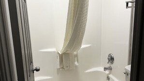 A bathroom with a bathtub, a toilet, and a shower. - Studio 6 Suites Louisville, KY – Airport/Expo Center (Louisville)