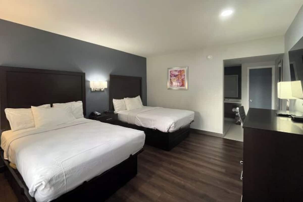 Desk, laptop workspace, blackout drapes, bed sheets