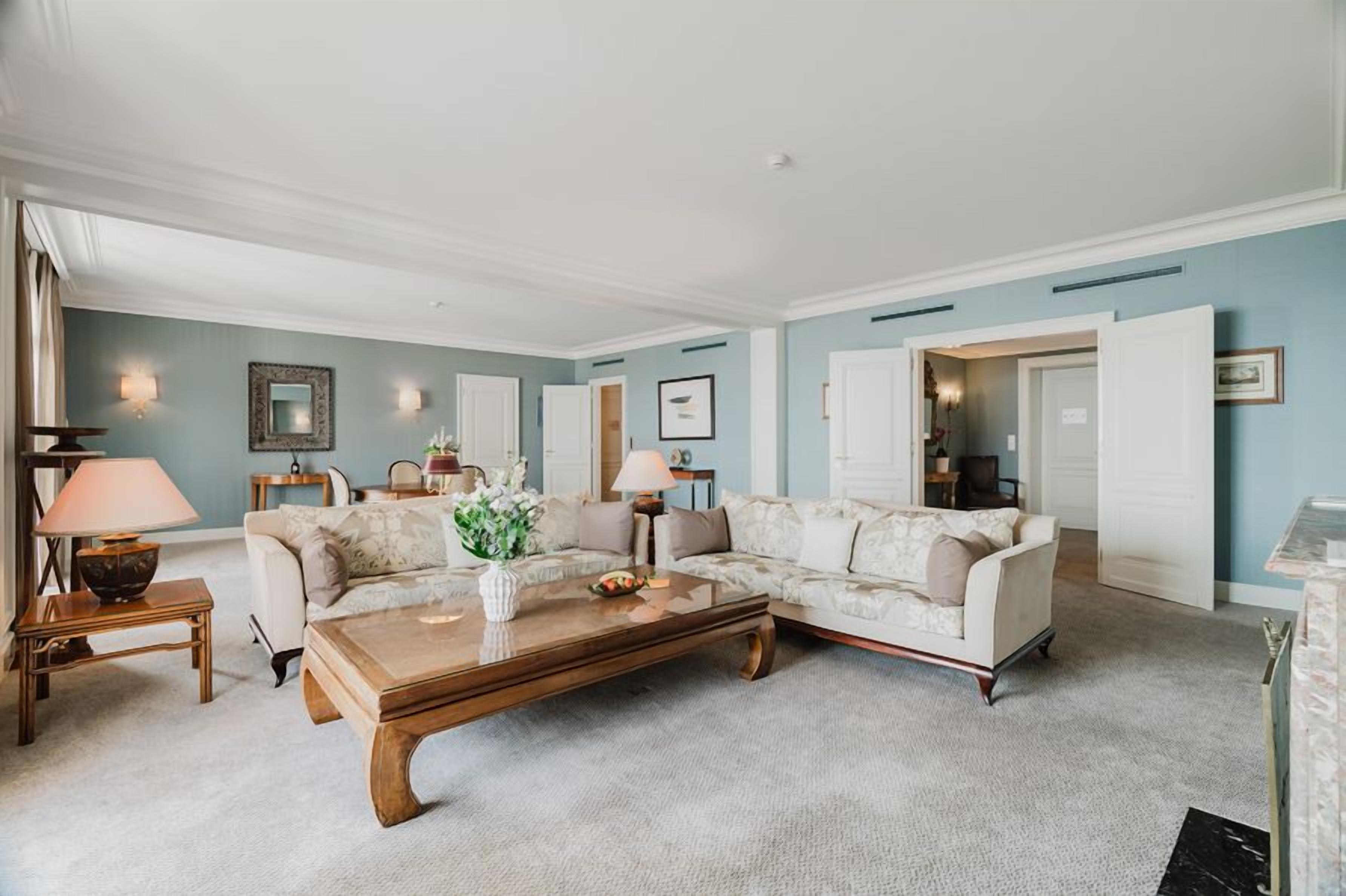 A living room with a sectional sofa, a coffee table, and a lamp.