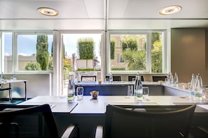A modern dining area with a large window, a bar counter, and a seating arrangement.