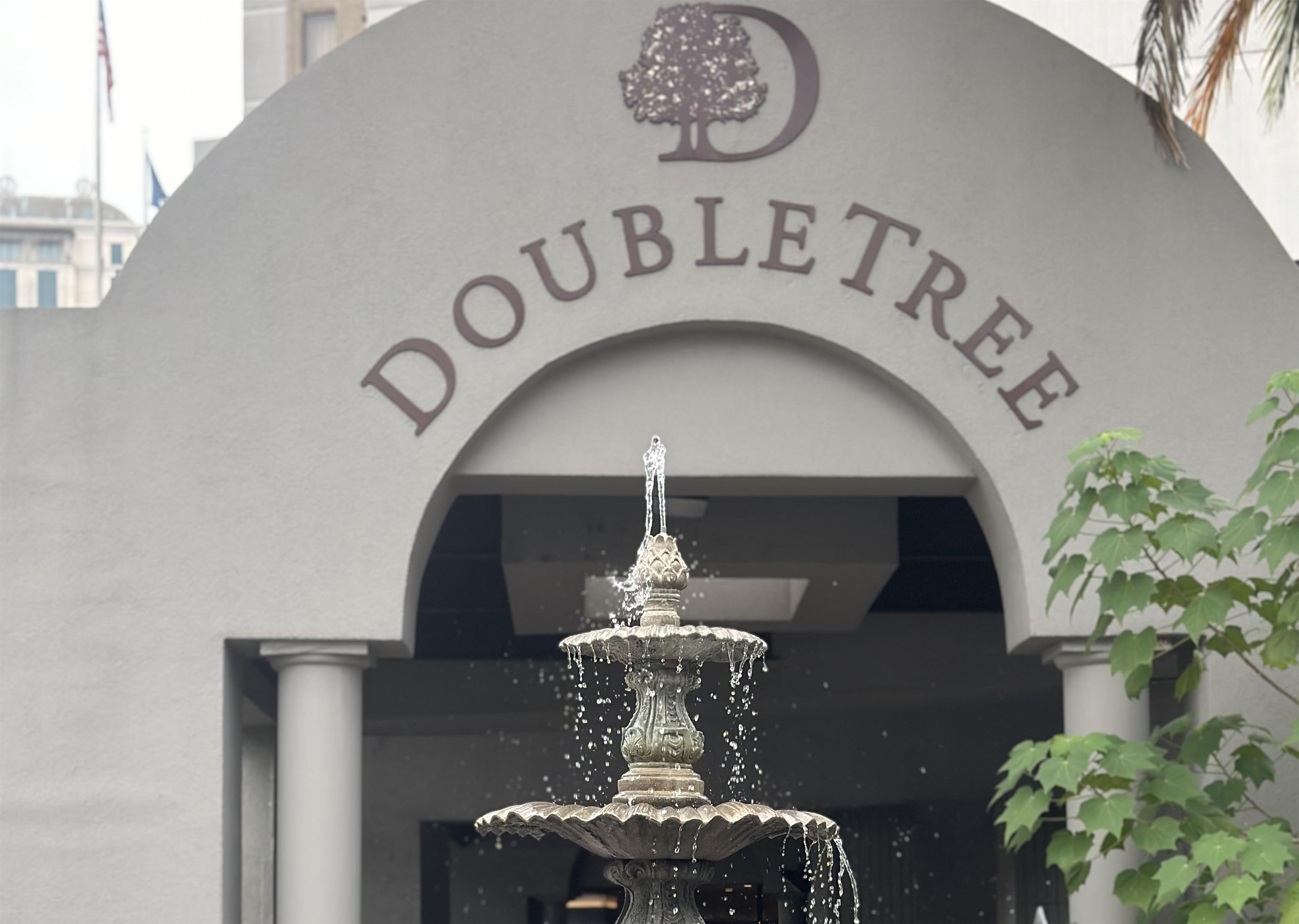 A fountain in front of a building with the sign 'DOUBLETREE'.