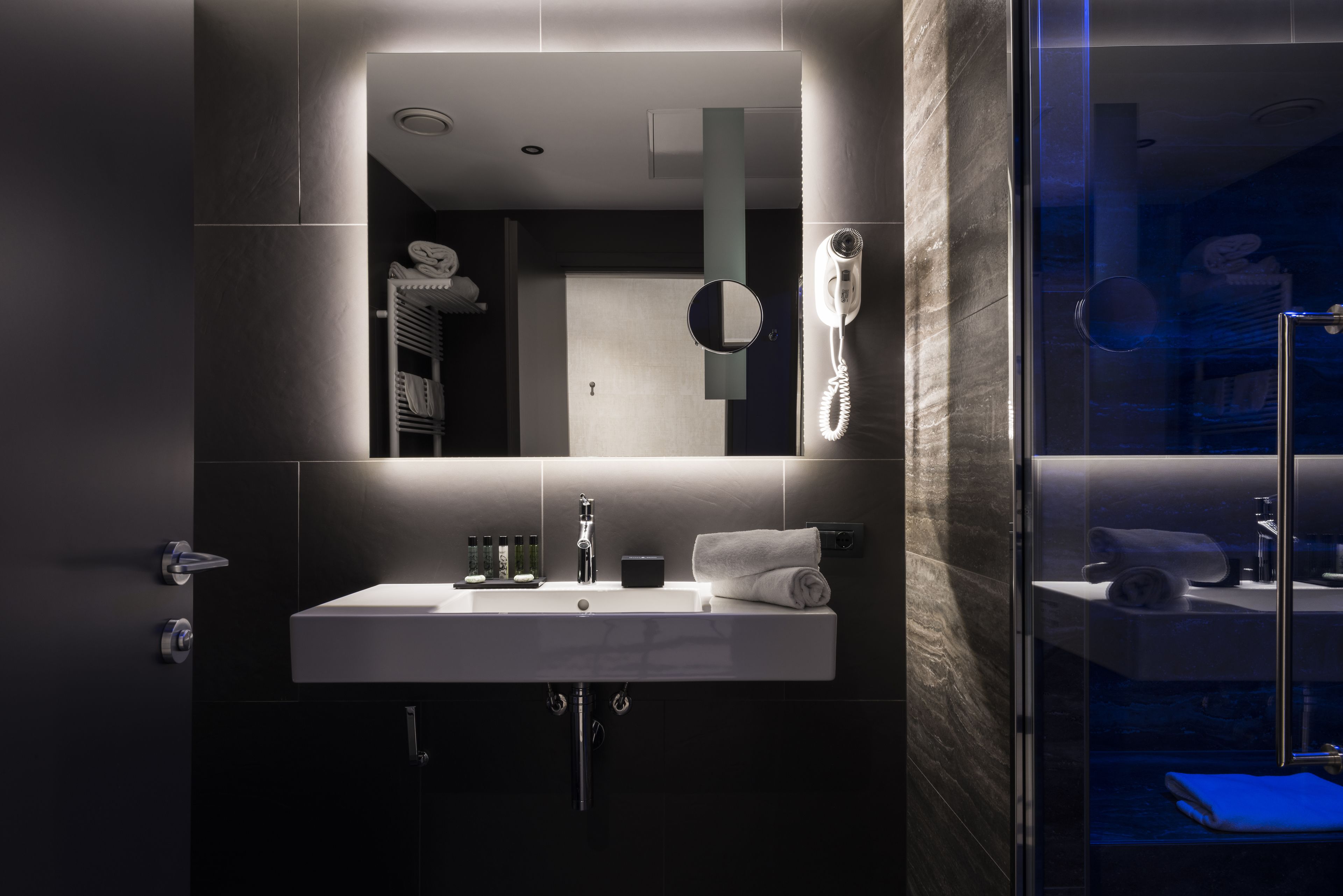 designer toiletries, hair dryer, slippers, bidet