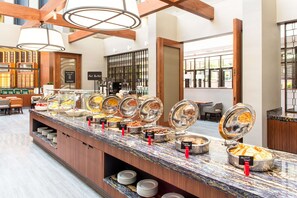A buffet with various food stations, including a French toast station, in a modern hotel setting. - Embassy Suites by Hilton Washington DC Georgetown (Washington)