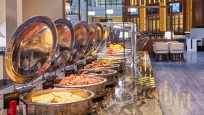 A buffet with various food items like waffles, bacon, and sausages. - Embassy Suites by Hilton Washington DC Georgetown (Washington)