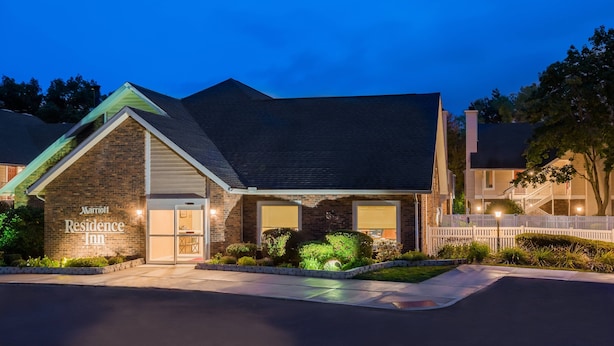 A brick building with a sign reading "Marriott Residence Inn" at the entrance, surrounded by landscaped greenery and a gated driveway. - Residence Inn by Marriott Hartford/Windsor (Windsor)